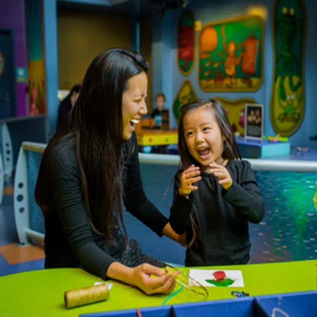 A mother and her young child having fun creating art