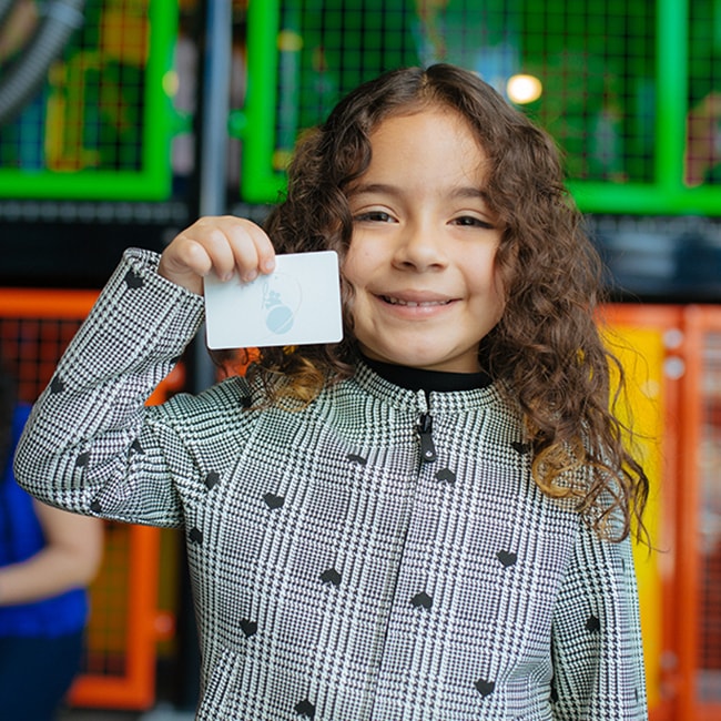 Child holding a membership card