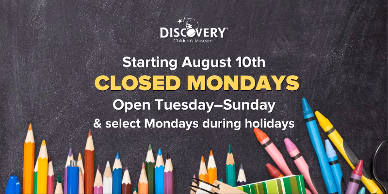 Website pop-up announcing that DISCOVERY Children's Museum will be closed Mondays starting August 10th, open Tuesday–Sunday and select Mondays during holidays, displayed over a chalkboard background with school supplies.