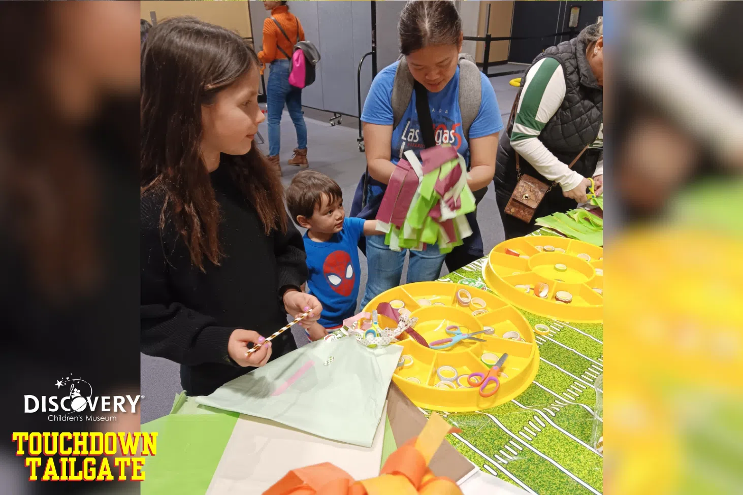 Children and parents cutting paper for arts and crafts at the Discovery Children's Museum