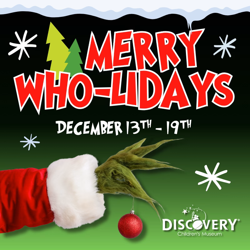 Merry Who-lidays (5) Square graphic with a Seuss-inspired holiday theme reading “Merry Who-Lidays, December 13th–19th.” The background fades from black to green with whimsical star shapes and pine trees. A Santa-sleeved arm and a green furry hand hold a red ornament. The DISCOVERY Children’s Museum logo appears in the bottom right corner.