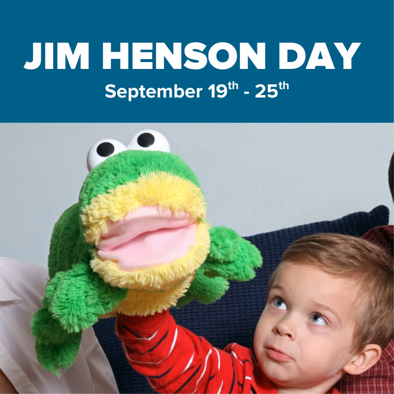 Promotional graphic for Jim Henson Day Puppets at DISCOVERY Children's Museum, September 19–25, featuring a child looking up at a green frog hand puppet.